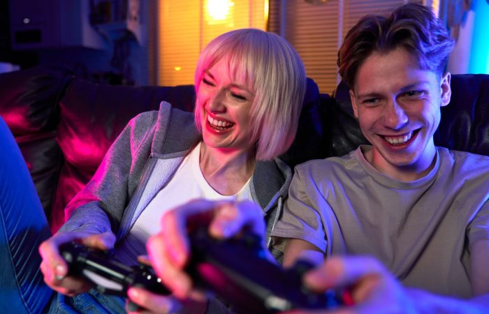 caucasian-couple-playing-video-game-with-game-pads-having-fun-1